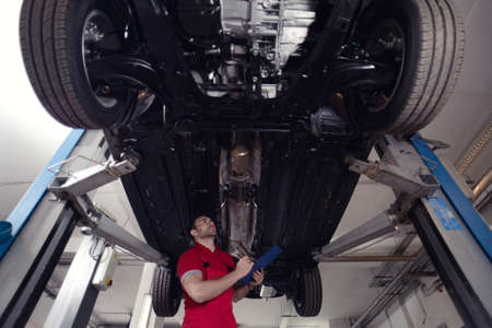 Mechanic repairing a car in garage