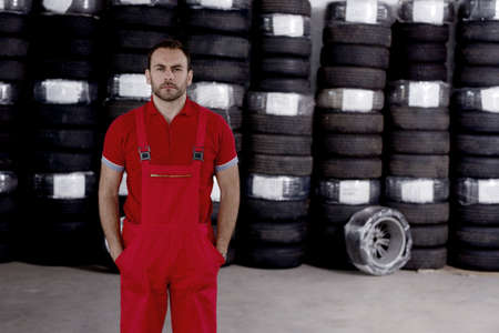 Mechanic repairing a car in garageの写真素材