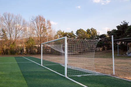 Autumn sky and blue grass on soccer field