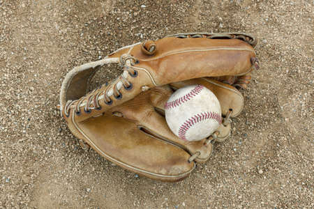 A baseball glove in a baseball diamondの写真素材