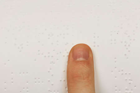 A finger on a book of brailleの写真素材