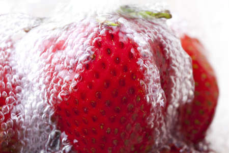Red strawberries in waterの写真素材