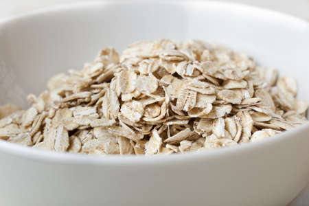 Dry Oatmeal in a bowlの写真素材