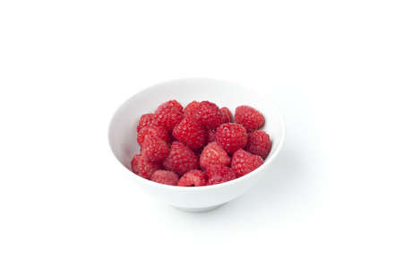 Fresh red raspberries against a white backgroundの写真素材