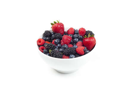 A group of berries in a bowl against a white backgroundの写真素材