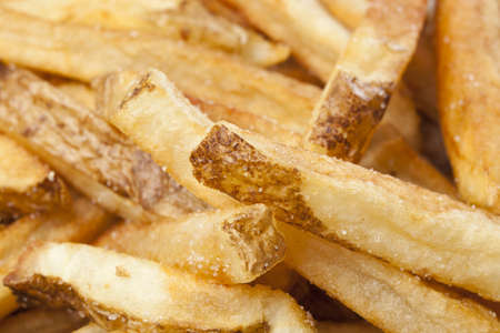 A group of hot french fries against a white backgroundの写真素材