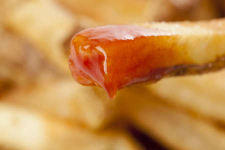 A group of hot french fries against a white background
