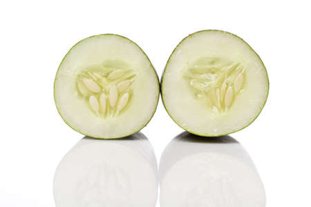 A sliced green cucumber against a white backgroundの写真素材