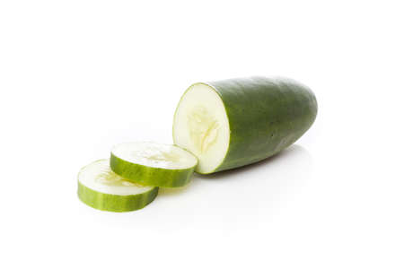 A sliced green cucumber against a white backgroundの写真素材
