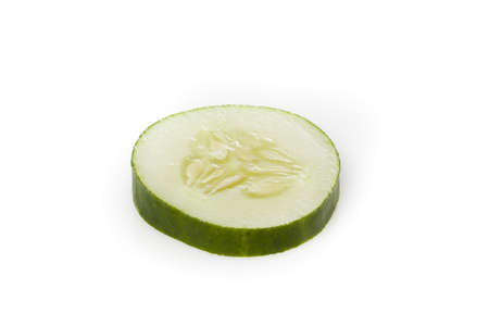 A sliced green cucumber against a white backgroundの写真素材