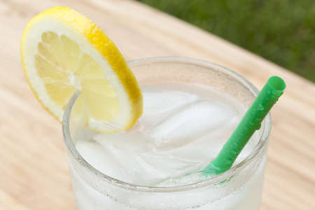 An ice cold lemonade on a wooden boardの写真素材