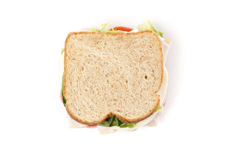 A large turkey sandwhich with tomatoes, cheese, and lettuceの写真素材