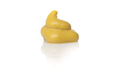 A yellow squirt of mustard against a white backgroundの写真素材