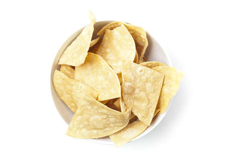 Fresh corn tortilla chips against a white backgroundの写真素材