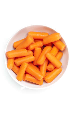 Fresh orange carrots against a white backgroundの写真素材