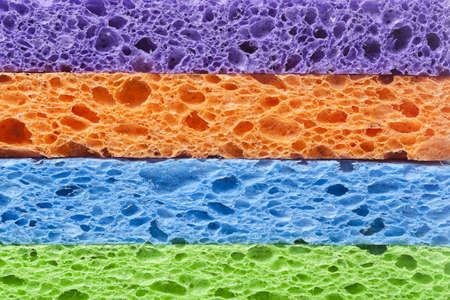 A colorful sponge used for cleaning against a white backgroundの写真素材