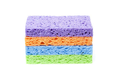 A colorful sponge used for cleaning against a white background