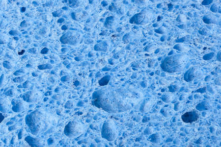 A colorful sponge used for cleaning against a white backgroundの写真素材