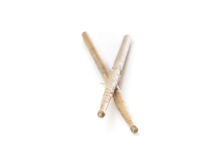 Wooden drum sticks against a white backgroundの写真素材