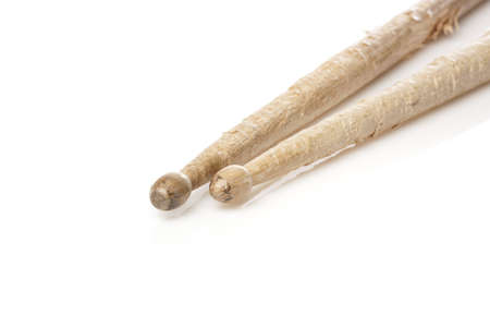 Wooden drum sticks against a white backgroundの写真素材