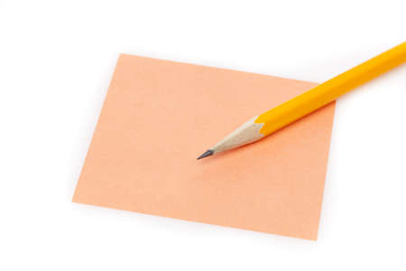 A colorful note pad with a pencil against a white backgroundの写真素材