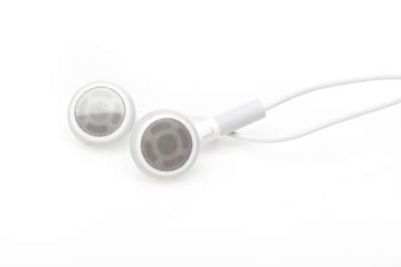 White ear buds against a white backgroundの写真素材