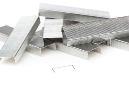 A stick of silver staples against a white backgroundの写真素材