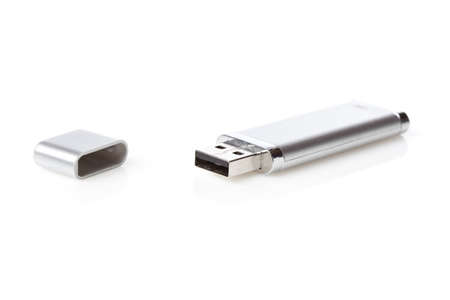 A silver USB jump drive isolated against a white background