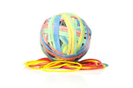 A colorful rubber band ball against a white backgroundの写真素材