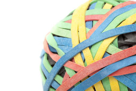 A colorful rubber band ball against a white backgroundの写真素材