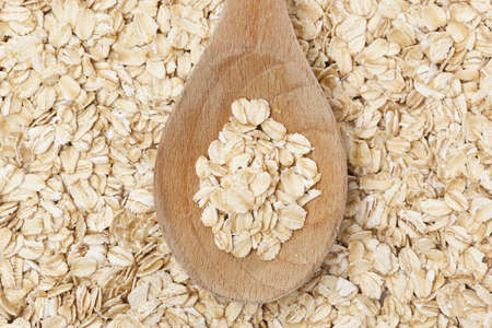 A Healthy Dry Oat meal in a wooden spoon