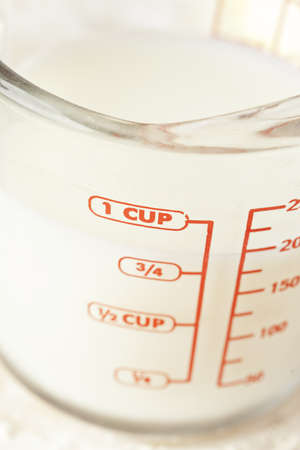 Clear White milk in a measuring cupの写真素材