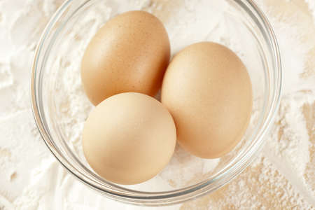 An Organic Brown Chicken Egg on a wooden board
