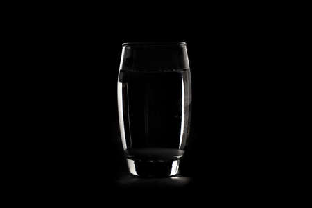 Fresh Clear Water in a glass against a backgroundの写真素材