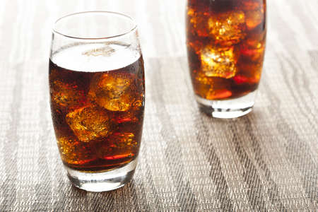 Refreshing Brown Soda with Ice on a backgroundの写真素材