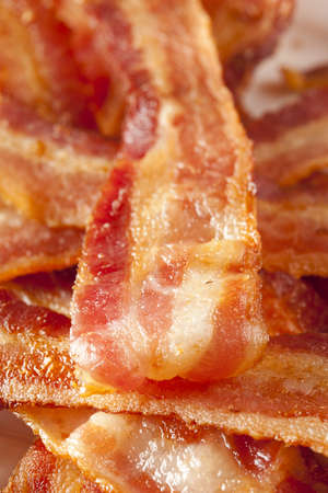 Cooked Greasy Bacon against a back groundの写真素材