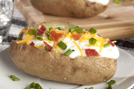 Hot Baked Potato with chives, cheese, and sour creamの写真素材