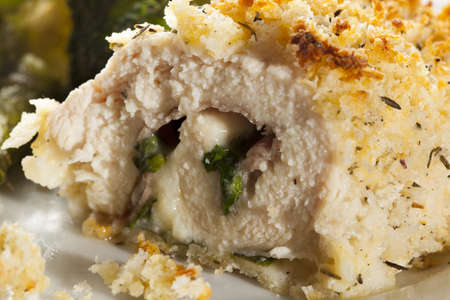 Breaded Homemade Chicken Cordon Bleu with fresh vegetablesの写真素材