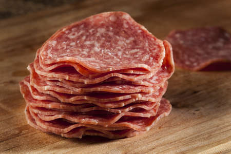 Fresh Cut Organic Salami against a background