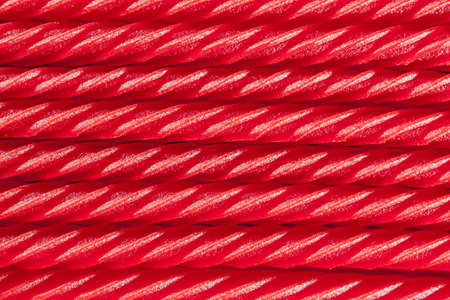 Bright Red Licorice Candy shaped like a twisted ropeの写真素材
