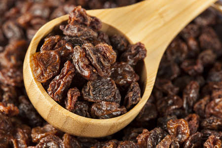 Organic Dried Raw Raisins against a backgroundの写真素材