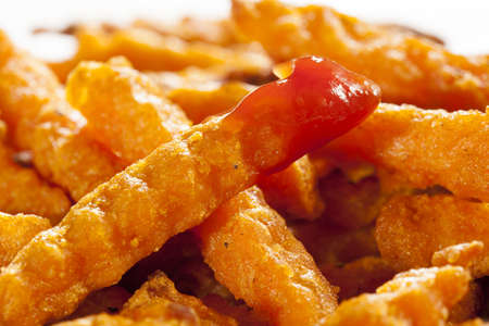 Cripsy Organic Sweet Potato Fries with pepper on parchment paper