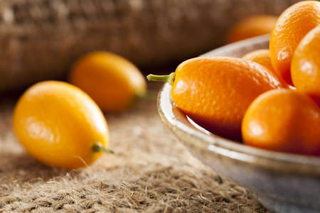 Fresh Organic Raw Kumquats Citrus Fruit against a backgroundの写真素材