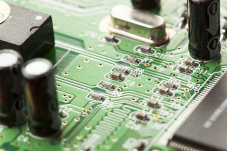 Green Electrical Circuit Board with microchips, conductors, and transistors