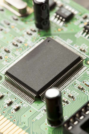 Green Electrical Circuit Board with microchips, conductors, and transistors