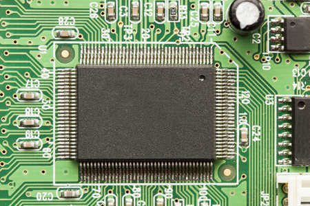 Green Electrical Circuit Board with microchips, conductors, and transistorsの写真素材