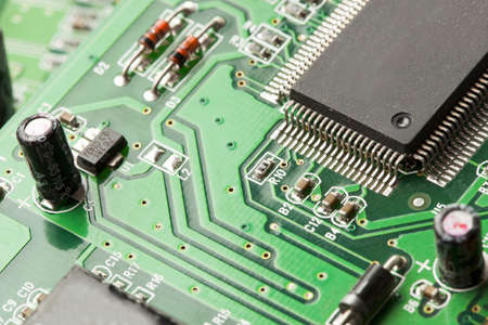 Green Electrical Circuit Board with microchips, conductors, and transistors