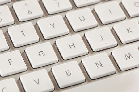 Grey Computer Keyboard with white keys for typing