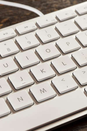 Grey Computer Keyboard with white keys for typing