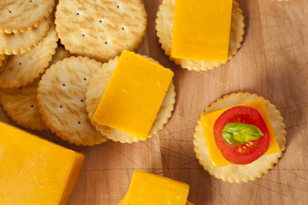 Chedder Cheese and Cracker Appetizer with tomato and basilの写真素材